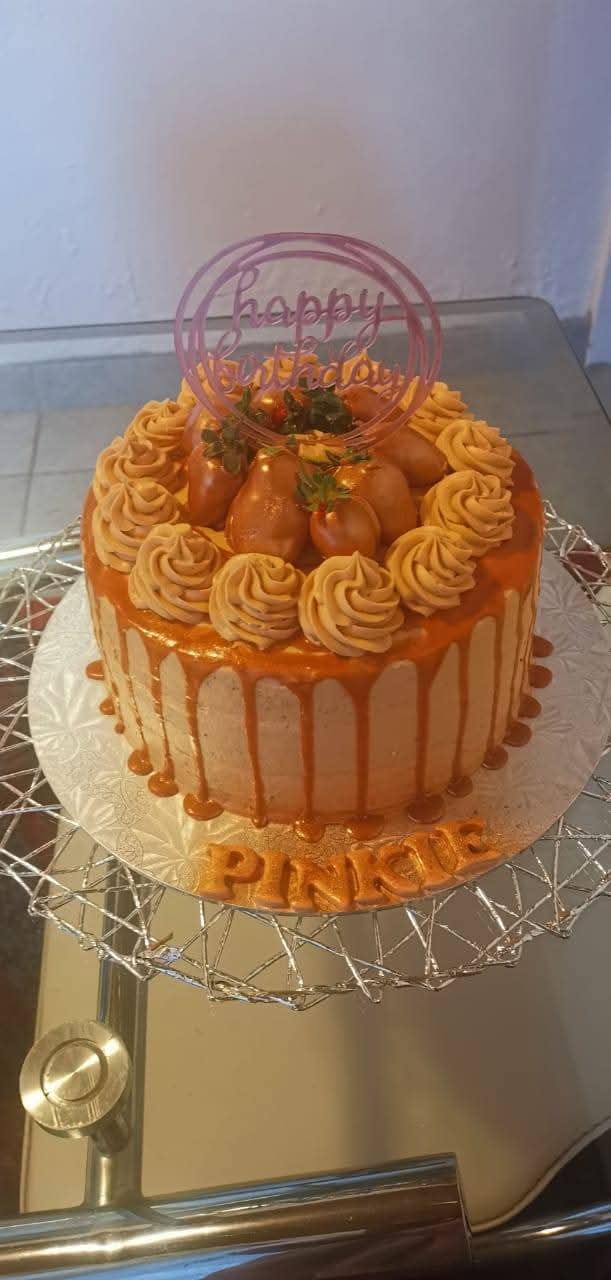 Caramel drip cake topped with chocolate-dipped strawberries