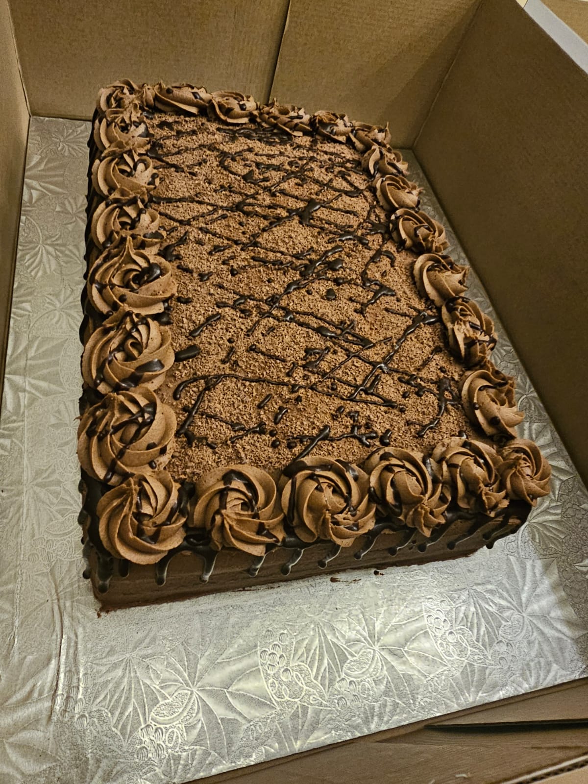 Large chocolate slab cake piped with rosettes