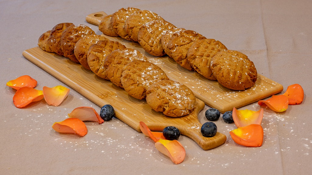 Ginger biscuits lined up on a board