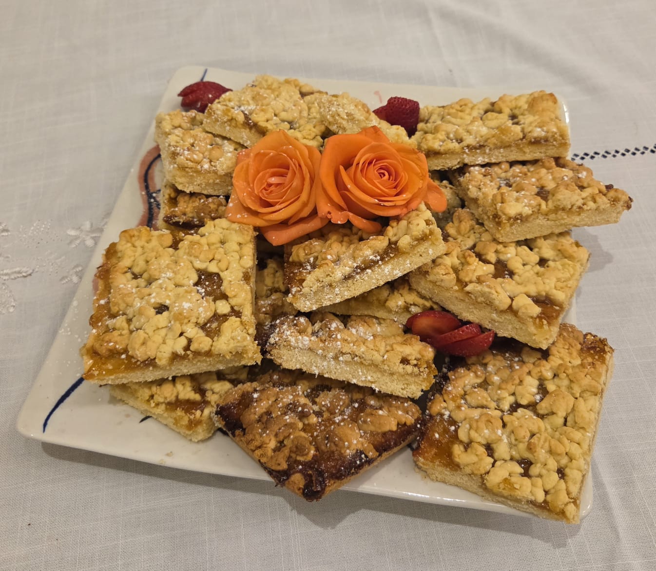 Apricot jam crumble squares dusted with icing sugar